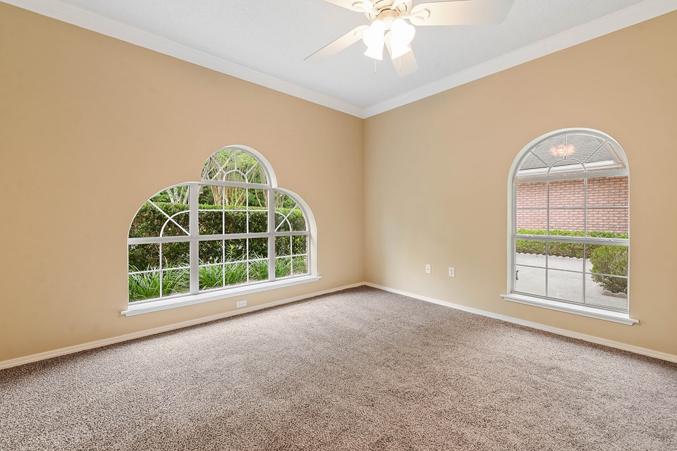 spacious bedroom second bedroom with ceiling fan walk in closet